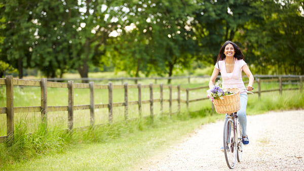 Happy woman rides a bicycle
